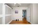 Bedroom boasts wood floors, and a closet with modern barn doors and a peak to the laundry room at 2104 W End Ave, Lakeland, FL 33803