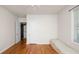 Bright bedroom with wood floors, big windows and an open door leading to another room at 2104 W End Ave, Lakeland, FL 33803
