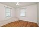 A bedroom with wood floors and large windows providing natural light, perfect for relaxation at 2104 W End Ave, Lakeland, FL 33803