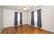 Sun-filled bedroom with hardwood floors, ceiling fan, and two bright windows at 2104 W End Ave, Lakeland, FL 33803
