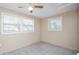 Cozy bedroom with tile floors, a ceiling fan, and two large windows for natural light at 2104 W End Ave, Lakeland, FL 33803