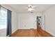 Inviting bedroom featuring wood floors, bright windows and a door to the laundry room at 2104 W End Ave, Lakeland, FL 33803