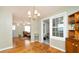 Open dining room with hardwood floors, a chandelier, and seamless access to the living area at 2104 W End Ave, Lakeland, FL 33803