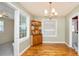 Charming dining room featuring hardwood floors, a chandelier, and a built-in display cabinet at 2104 W End Ave, Lakeland, FL 33803