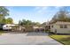 A home with a long driveway, carport, and covered outdoor area, offering ample parking and storage at 2104 W End Ave, Lakeland, FL 33803