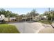 A well-maintained home with a spacious driveway, carport, and covered outdoor area for entertaining or storage at 2104 W End Ave, Lakeland, FL 33803