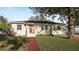 Charming single-story home with a vibrant red brick walkway leading to the entrance, complemented by a well-maintained lawn at 2104 W End Ave, Lakeland, FL 33803