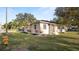 Charming single-story home with a well-kept lawn, complemented by flowering plants and a neatly paved walkway at 2104 W End Ave, Lakeland, FL 33803