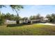 Well-maintained front yard with a parked RV and a cozy home with a covered carport, creating a welcoming and functional outdoor space at 2104 W End Ave, Lakeland, FL 33803
