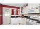 Charming kitchen featuring white cabinets, sleek black countertops, and a stylish black-and-white checkered floor at 2104 W End Ave, Lakeland, FL 33803