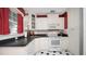 White cabinetry and appliances, along with sleek countertops and checkered floors, make this a cozy kitchen at 2104 W End Ave, Lakeland, FL 33803