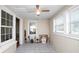 Bright sun room featuring tile floors, multiple windows, and a ceiling fan for year-round enjoyment at 2104 W End Ave, Lakeland, FL 33803