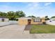 Charming single-story home with a large driveway and fenced front yard at 2111 S Lincoln Ave, Lakeland, FL 33803