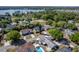 A residential neighborhood featuring houses, green trees, a swimming pool, and a lake in the background at 221 Stevenson Rd, Winter Haven, FL 33884