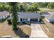 Charming single-Gathering home with a well-manicured front yard, long driveway, and a two-car garage at 221 Stevenson Rd, Winter Haven, FL 33884