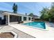 Beautiful backyard featuring a sparkling blue pool, patio area, and lush landscaping at 221 Stevenson Rd, Winter Haven, FL 33884