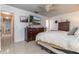 Bedroom featuring tile floors, a ceiling fan, a television mounted on the wall, and a dark dresser at 221 Stevenson Rd, Winter Haven, FL 33884