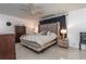 Bedroom with tile floors, ceiling fan, a gray headboard bed, and a dark wood dresser at 221 Stevenson Rd, Winter Haven, FL 33884