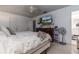 Bedroom featuring tile floors, a ceiling fan, a television mounted on the wall, and a dark dresser at 221 Stevenson Rd, Winter Haven, FL 33884