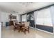 Dining room featuring dark accent wall, modern lighting, and neutral tile floors at 221 Stevenson Rd, Winter Haven, FL 33884