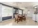 Dining room featuring dark accent wall, modern lighting, and neutral tile floors at 221 Stevenson Rd, Winter Haven, FL 33884