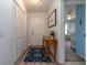 Inviting entryway with a wooden table, rug, and closet, leading into a bedroom at 221 Stevenson Rd, Winter Haven, FL 33884