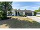 Charming single-story home featuring a well-maintained front yard and a two-car garage at 221 Stevenson Rd, Winter Haven, FL 33884