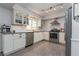 Well-lit kitchen featuring white cabinets, stainless steel appliances, and modern fixtures at 221 Stevenson Rd, Winter Haven, FL 33884
