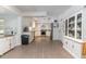 Open floor plan showing kitchen with white cabinets and appliances, and adjacent dining area at 221 Stevenson Rd, Winter Haven, FL 33884
