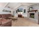 Cozy living room with a brick fireplace, comfortable seating, and a mounted television at 221 Stevenson Rd, Winter Haven, FL 33884