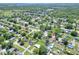 An aerial shot of a neighborhood featuring a house with a pool and green yard at 2329 Duff Rd, Lakeland, FL 33810