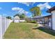 Large backyard with privacy fence, storage building, fire pit, and screened in pool enclosure at 2329 Duff Rd, Lakeland, FL 33810