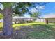 Spacious backyard view with a pool enclosure, backyard barn and mature shade trees at 2329 Duff Rd, Lakeland, FL 33810