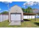 Exterior view of backyard barn with white siding, brown trim, concrete ramp, and covered carport at 2329 Duff Rd, Lakeland, FL 33810