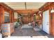 Barn interior with wood paneling, overhead storage, workbench, tools and a closed white entry door at 2329 Duff Rd, Lakeland, FL 33810