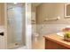 Well-lit bathroom with a walk-in shower, wainscoting, and peach-colored vanity at 2329 Duff Rd, Lakeland, FL 33810