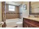 Updated bathroom with granite counters, bathtub, and tiled shower with decorative mosaic tile at 2329 Duff Rd, Lakeland, FL 33810