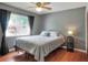 Bedroom with hardwood floors, a ceiling fan, and a large window at 2329 Duff Rd, Lakeland, FL 33810