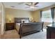 Comfortable bedroom featuring a large bed, soft lighting, and neutral color scheme at 2329 Duff Rd, Lakeland, FL 33810