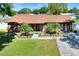 Well maintained brick home with mature landscaping, palm trees and a sidewalk leading to the front door at 2329 Duff Rd, Lakeland, FL 33810
