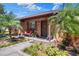 Inviting front porch showcasing brick accents, well-maintained landscaping, and a cozy seating area at 2329 Duff Rd, Lakeland, FL 33810