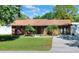 Charming single-story home with lush lawn, mature trees, and a well-maintained brick facade at 2329 Duff Rd, Lakeland, FL 33810