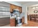 Modern kitchen with stainless steel appliances, wood cabinets, and view into dining area at 2329 Duff Rd, Lakeland, FL 33810