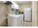 Functional laundry room with washer, dryer, refrigerator, and ample storage space at 2329 Duff Rd, Lakeland, FL 33810