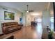 Spacious living room featuring hardwood floors, a ceiling fan, and comfortable leather sofas at 2329 Duff Rd, Lakeland, FL 33810