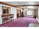 Spacious living room with breakfast bar, wood trim, and pink carpet, perfect for relaxing or entertaining at 2329 Duff Rd, Lakeland, FL 33810