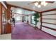 Expansive living area with wood trim, pink carpet, built-in shelves, and plenty of natural light at 2329 Duff Rd, Lakeland, FL 33810