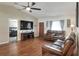 Open-concept living area with hardwood floors, a ceiling fan, and plenty of natural light at 2329 Duff Rd, Lakeland, FL 33810