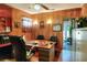 The home office features wood paneling, a ceiling fan, and a glimpse of the outdoors through an open doorway at 2329 Duff Rd, Lakeland, FL 33810