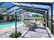 A screened-in pool area with an outdoor dining setup, making the area perfect for entertaining at 2329 Duff Rd, Lakeland, FL 33810